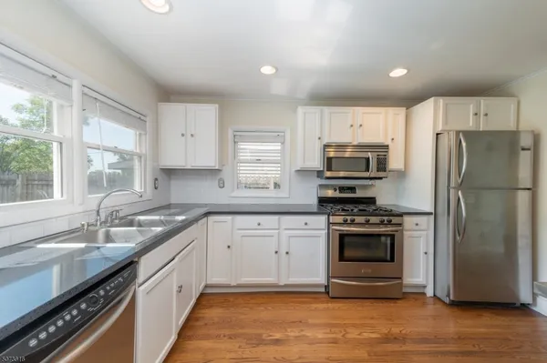 a kitchen with a sink stove and refrigerator