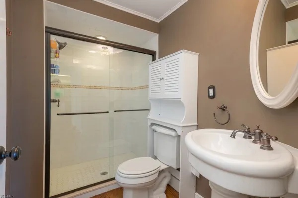 a bathroom with a sink toilet and a mirror
