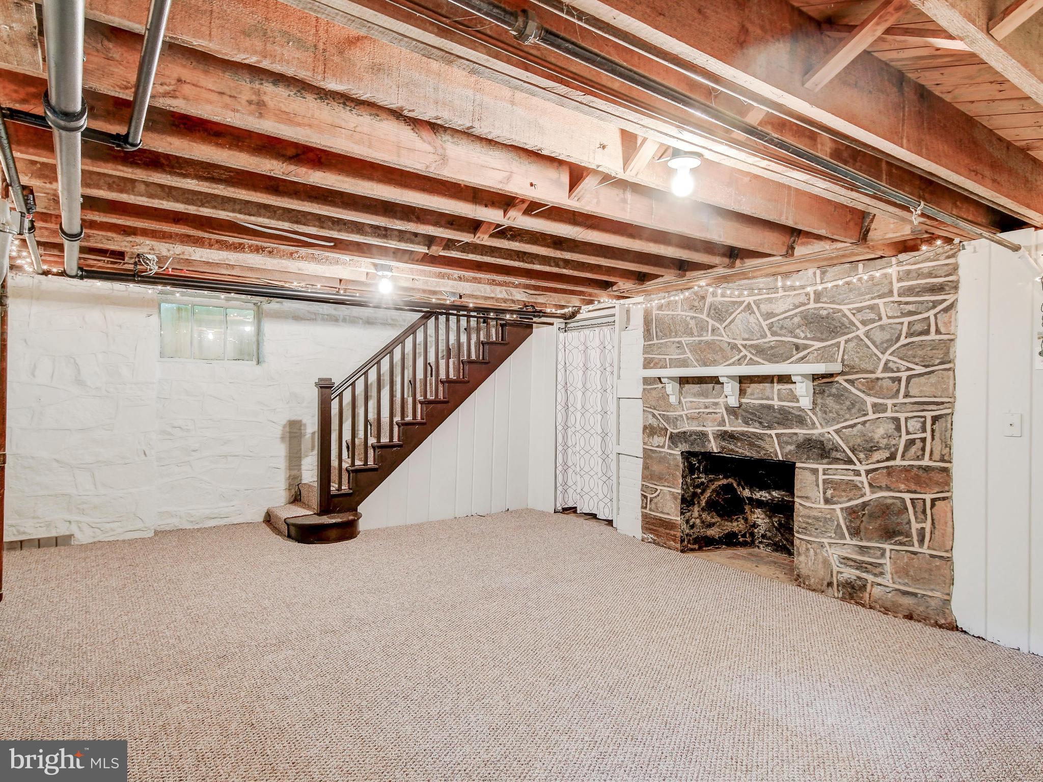 323 Taplow Road Baltimore, MD 21212 - Photo 34 of 41 Basement with Fireplace and Exposed Stone