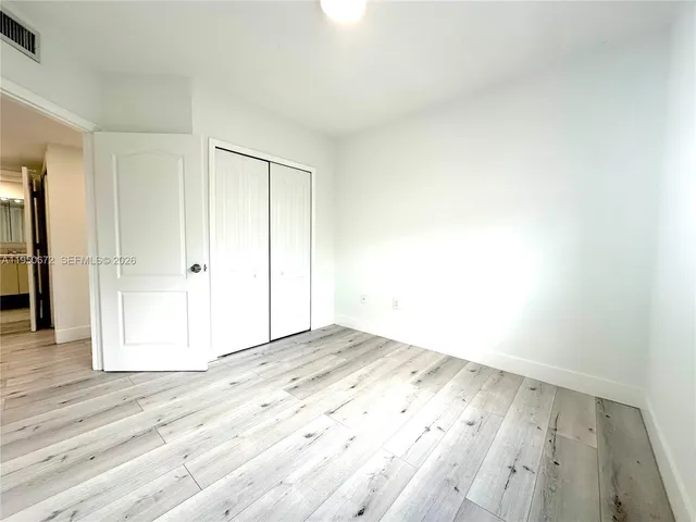 an empty room with wooden floor