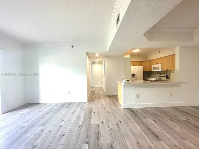 a view of kitchen with cabinets wooden floor and a sink
