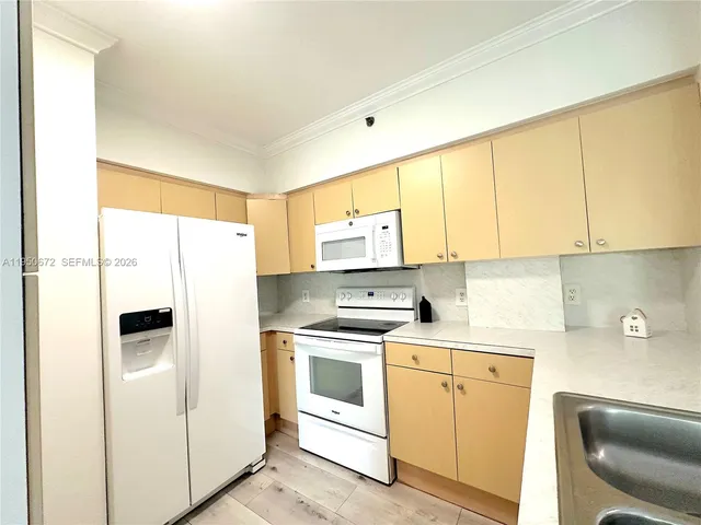 a kitchen with a white cabinets and white appliances