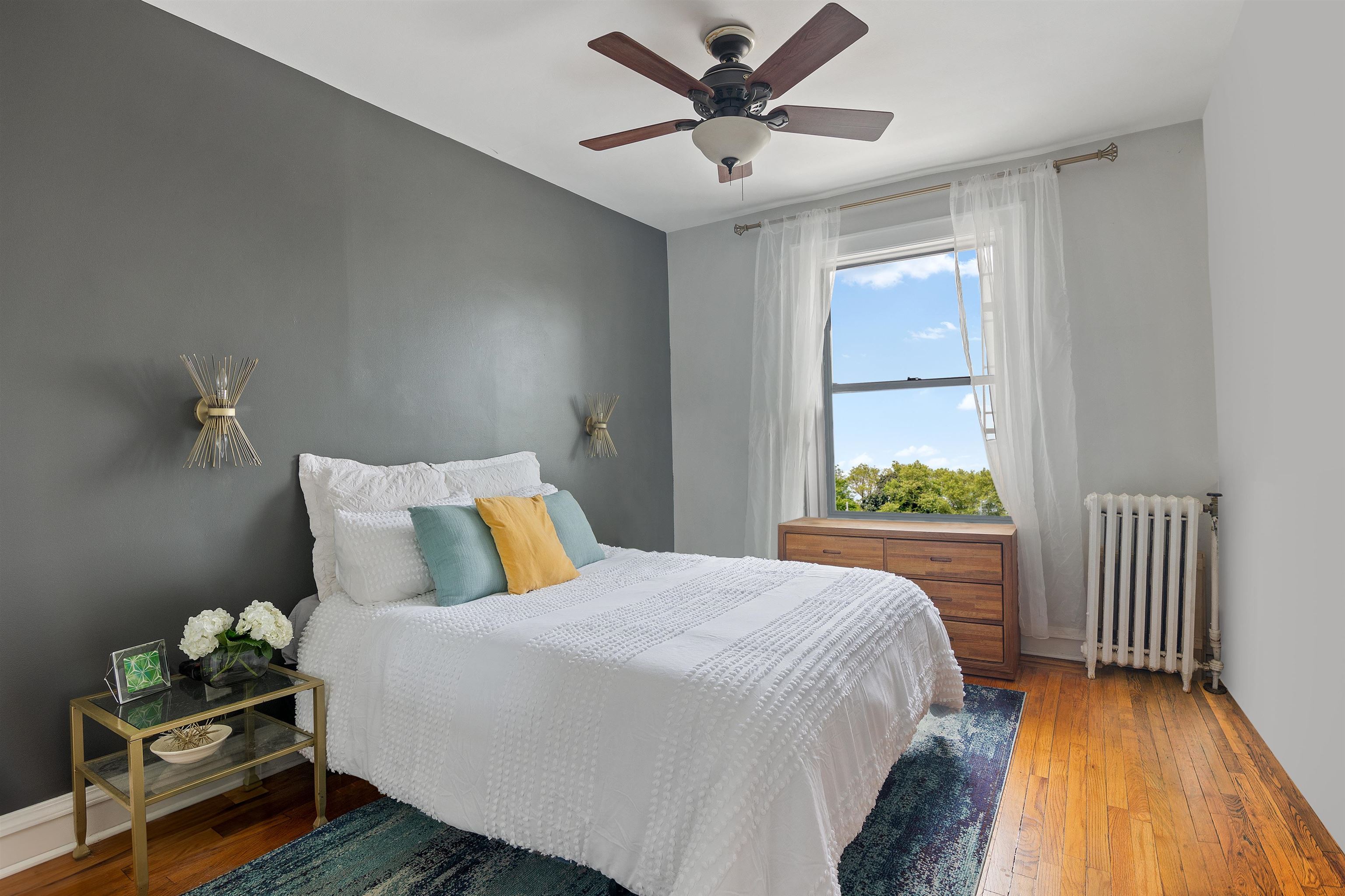 277 Harrison Avenue, Unit E6 Jersey City, NJ 07304 - Photo 6 of 14 a bed sitting in a bedroom next to a window