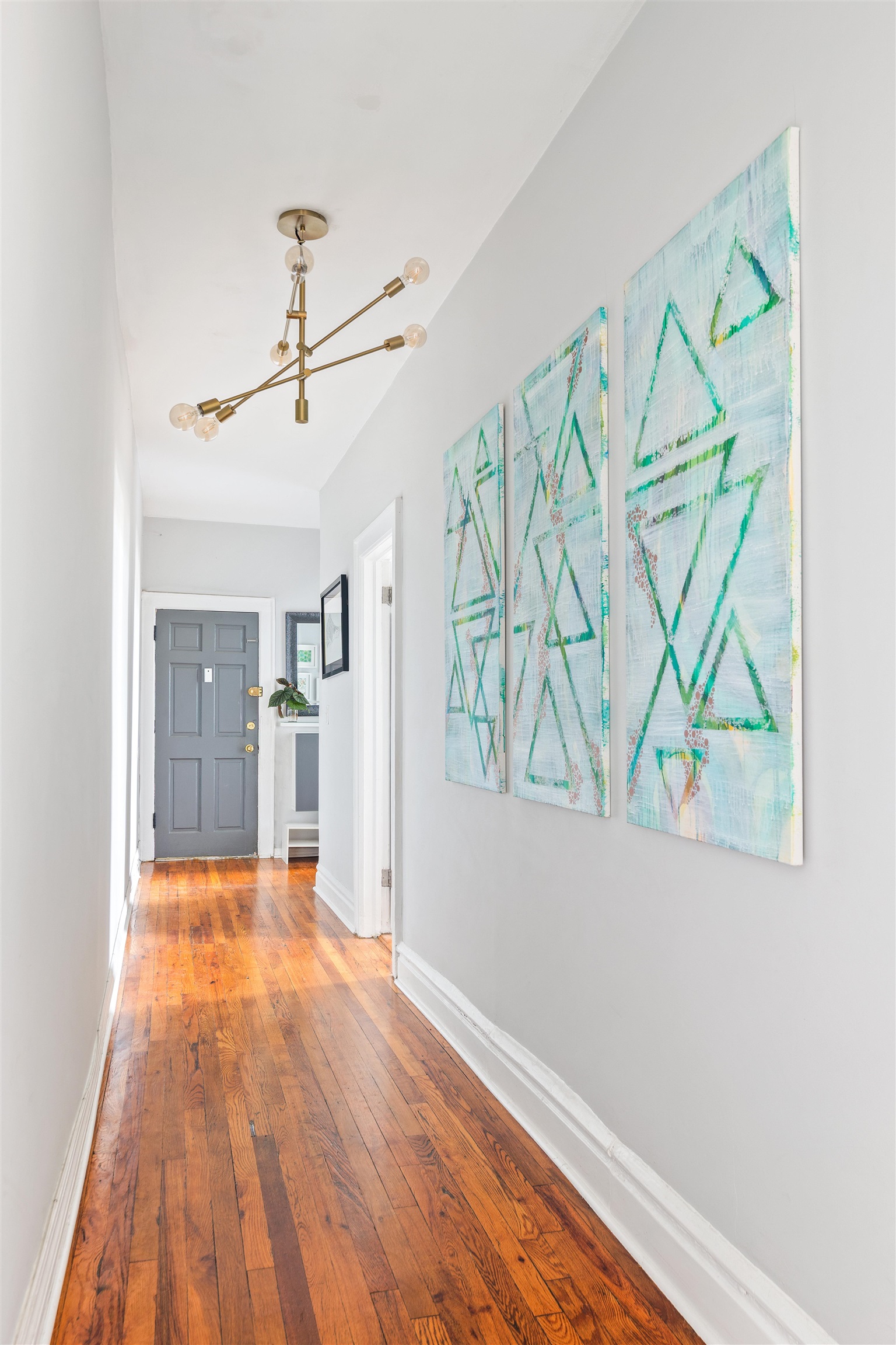 277 Harrison Avenue, Unit E6 Jersey City, NJ 07304 - Photo 8 of 14 a view of hallway with wooden floor and fan