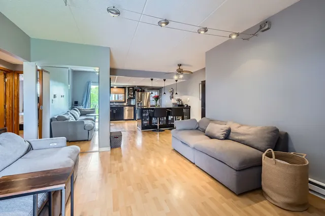 a living room with furniture and a wooden floor