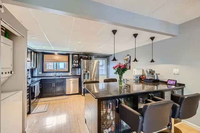 a view of a dining room with furniture and chandelier