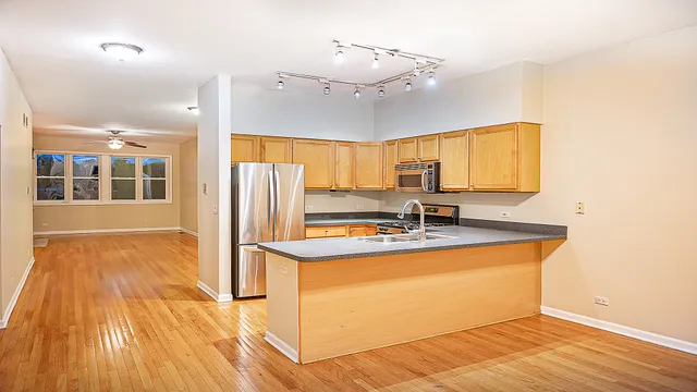 a view of a kitchen with a sink and cabinets