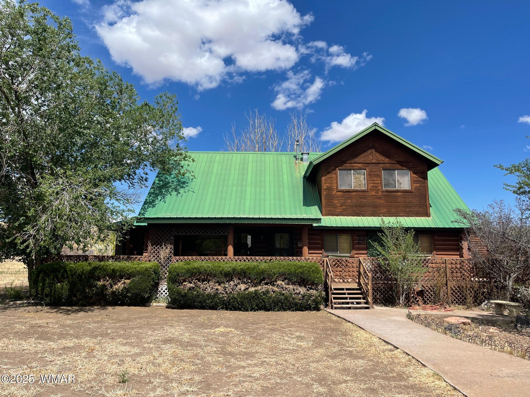 183 North Becker Lake Road Springerville, AZ 85938 - Photo 2 of 41 a front view of a house with a garden