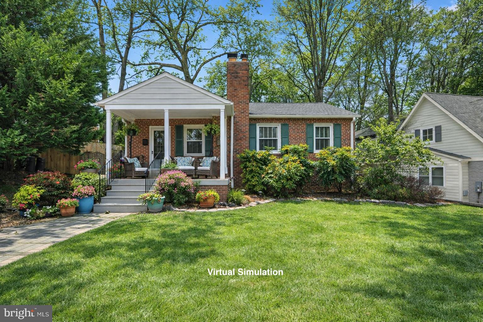 a front view of a house with a yard table and chairs