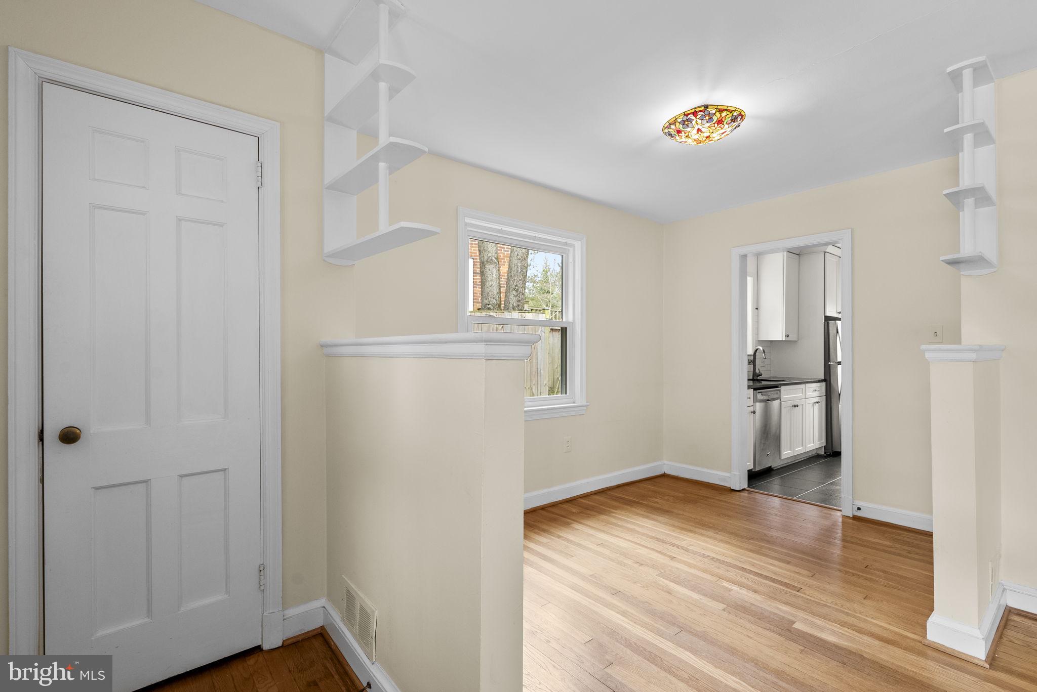 414 Hillmoor Drive Silver Spring, MD 20901 - Photo 16 of 49 a view of empty room with wooden floor and kitchen