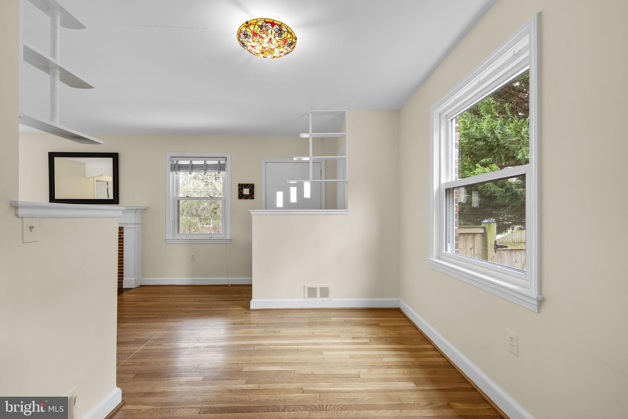 414 Hillmoor Drive Silver Spring, MD 20901 - Photo 19 of 49 a view of an empty room with wooden floor and a window