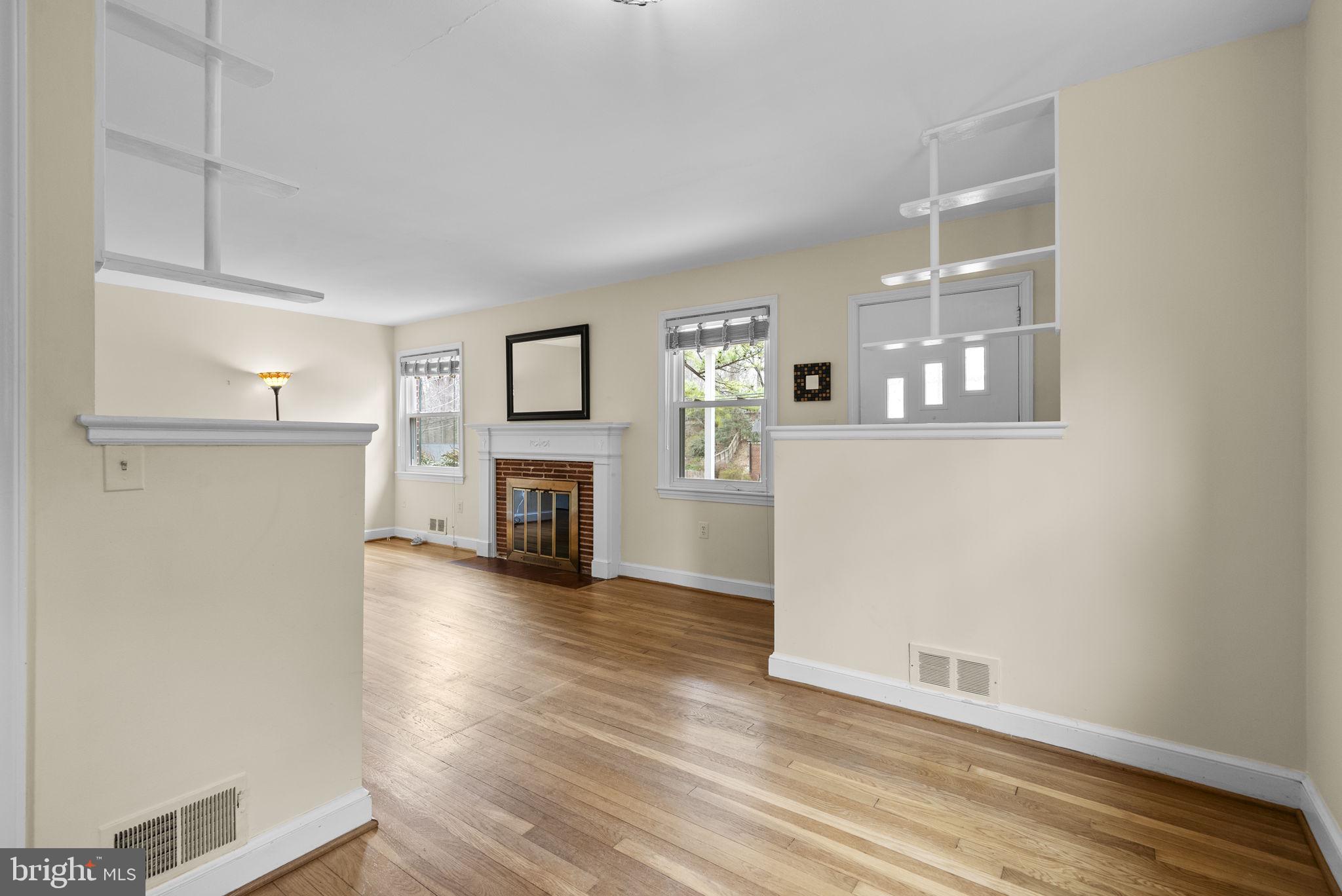414 Hillmoor Drive Silver Spring, MD 20901 - Photo 20 of 49 a view of a livingroom with wooden floor and a fireplace