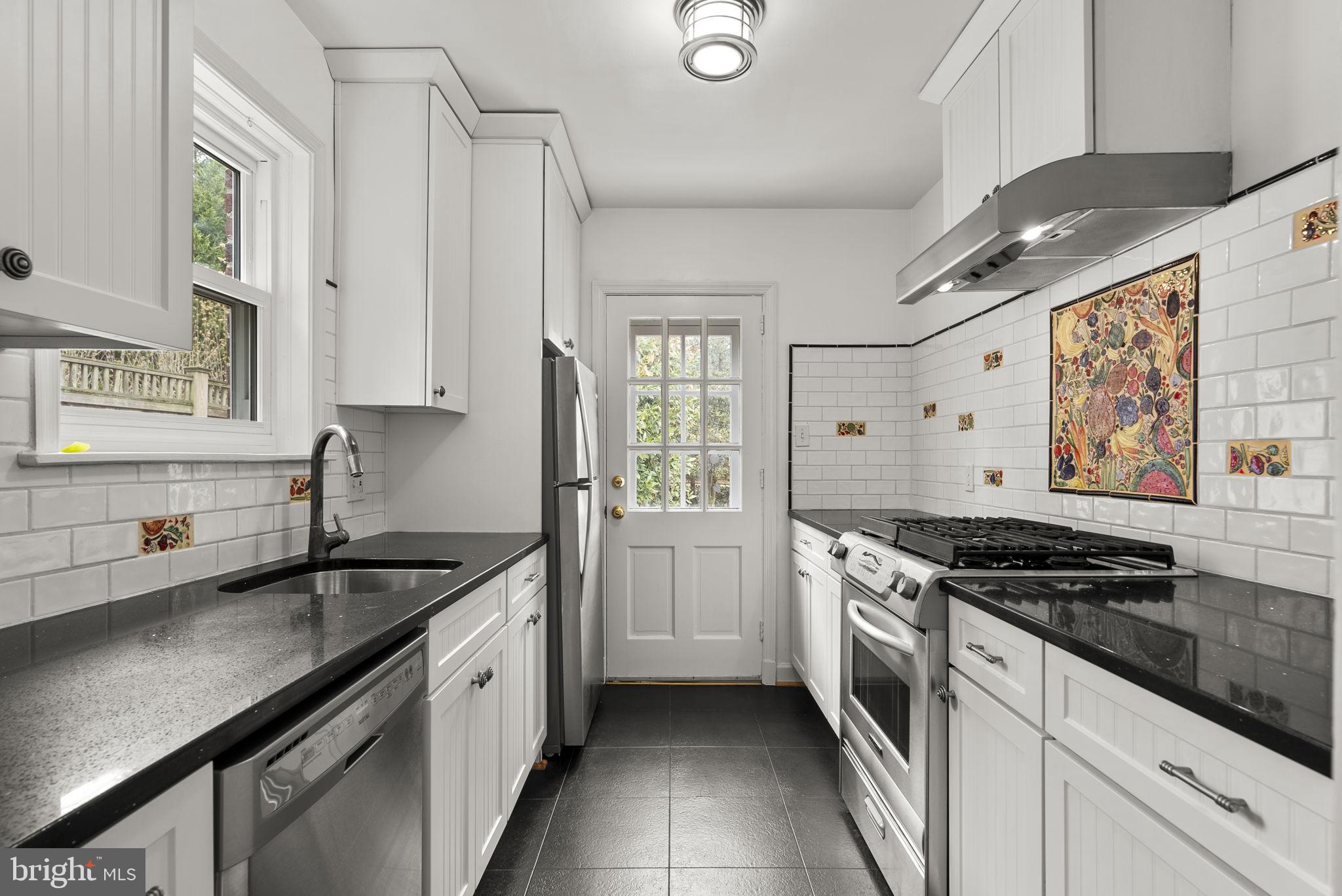 414 Hillmoor Drive Silver Spring, MD 20901 - Photo 21 of 49 a kitchen with stainless steel appliances granite countertop a sink stove and cabinets