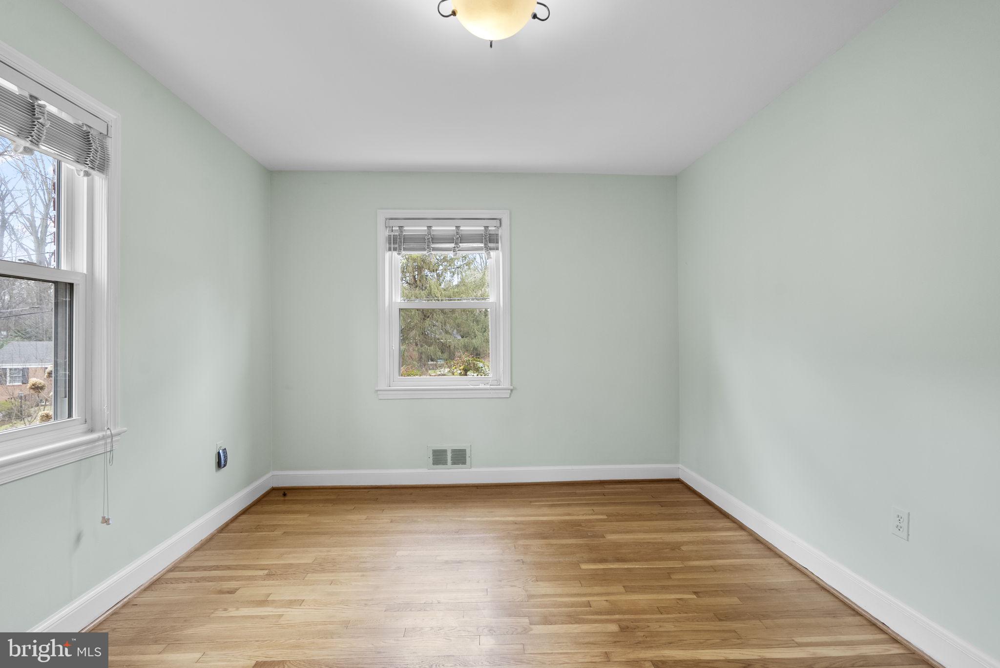 414 Hillmoor Drive Silver Spring, MD 20901 - Photo 28 of 49 wooden floor in an empty room with a window