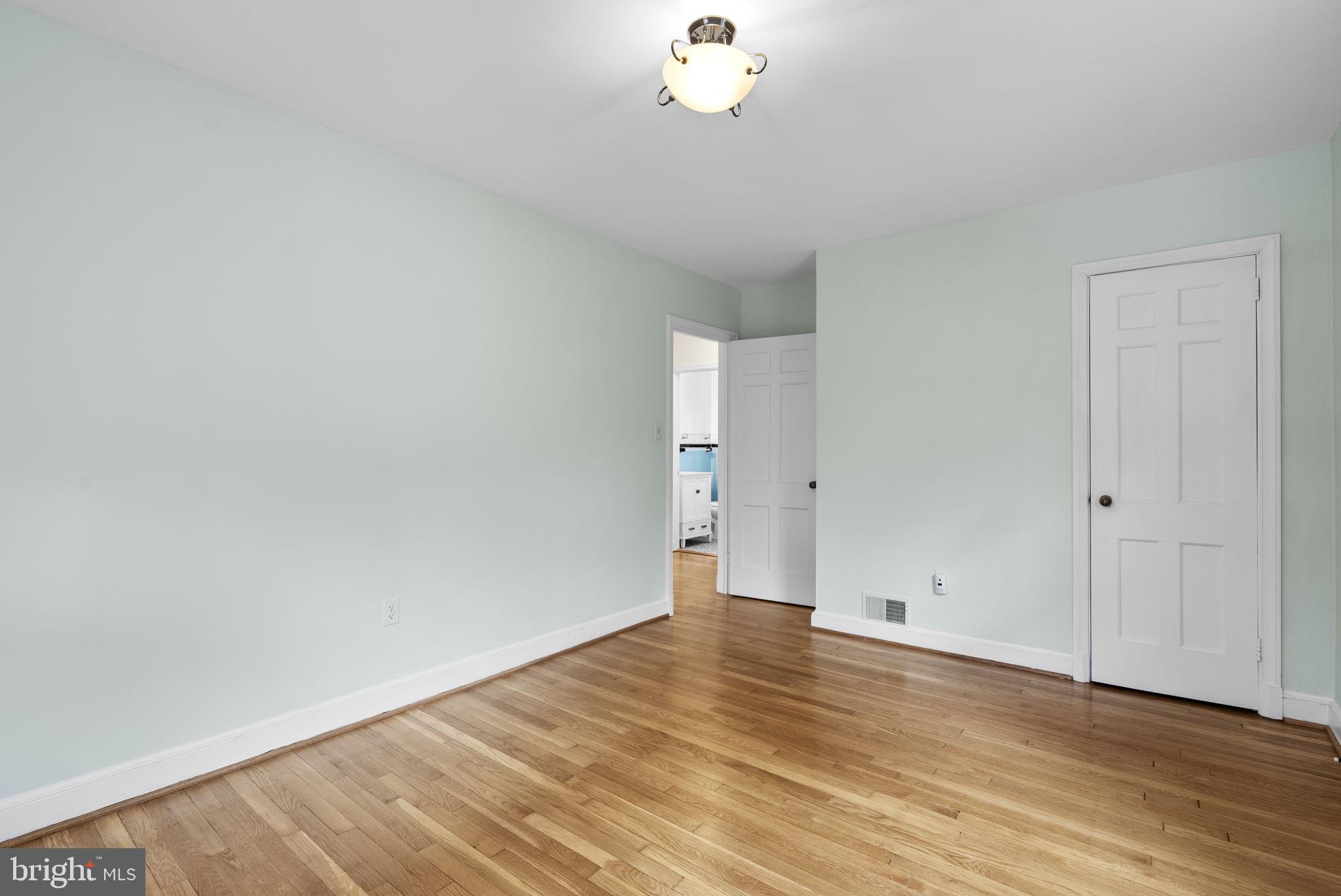 414 Hillmoor Drive Silver Spring, MD 20901 - Photo 29 of 49 a view of an empty room with wooden floor