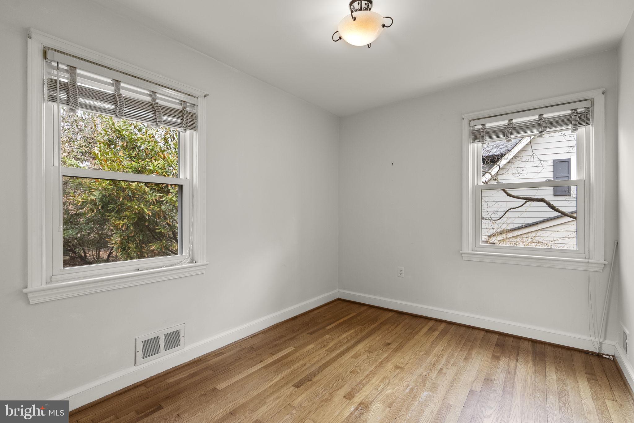 414 Hillmoor Drive Silver Spring, MD 20901 - Photo 31 of 49 a view of an empty room with wooden floor and a window