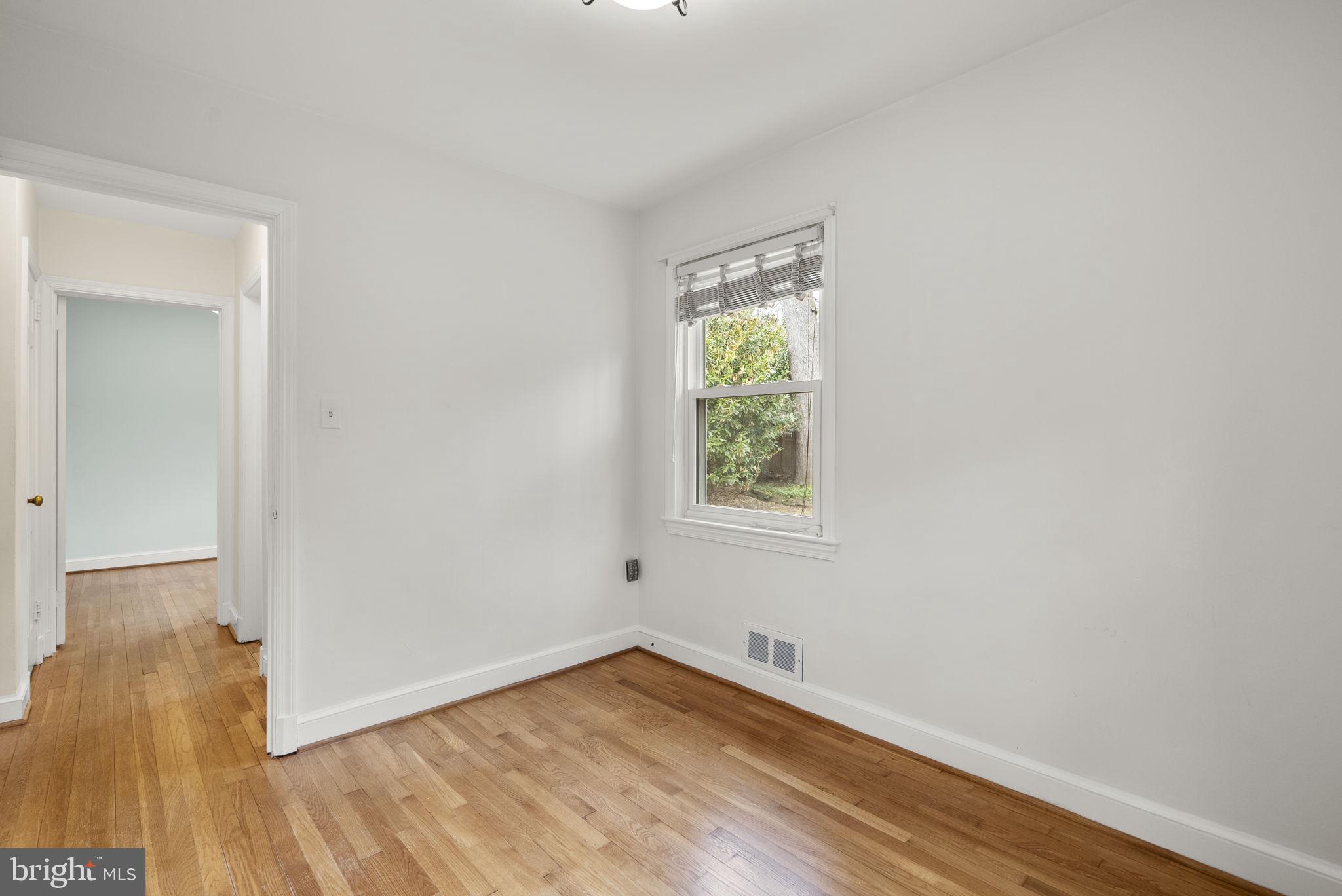 414 Hillmoor Drive Silver Spring, MD 20901 - Photo 34 of 49 an empty room with wooden floor and windows