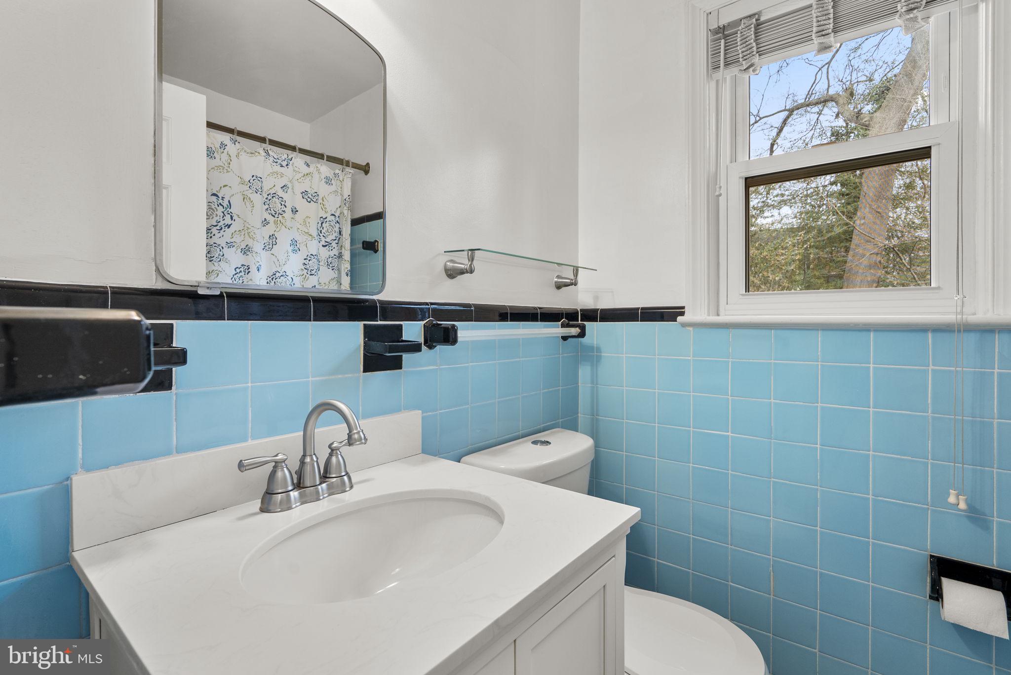 414 Hillmoor Drive Silver Spring, MD 20901 - Photo 35 of 49 a bathroom with a toilet sink and mirror