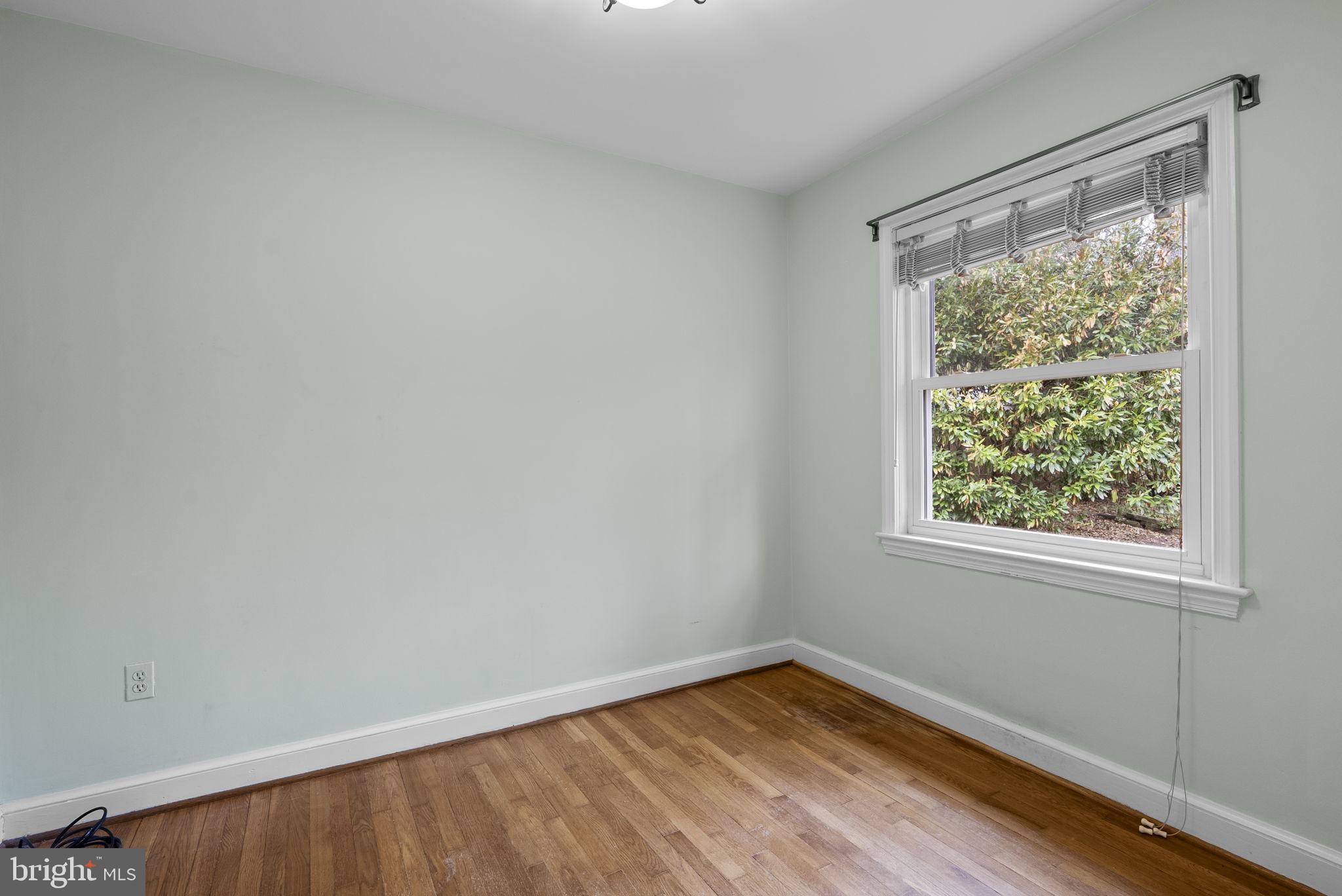414 Hillmoor Drive Silver Spring, MD 20901 - Photo 36 of 49 a view of an empty room with wooden floor and a window