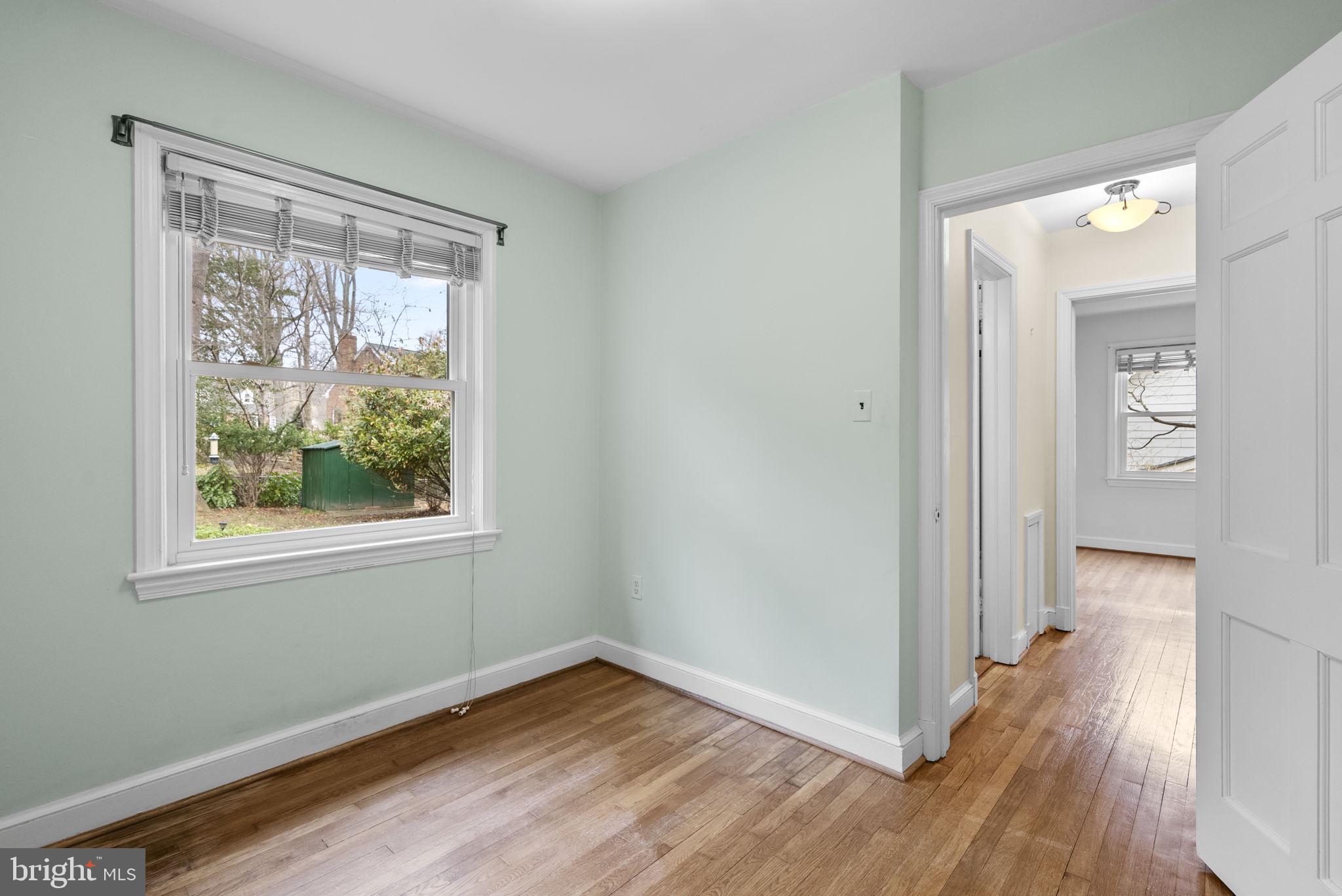 414 Hillmoor Drive Silver Spring, MD 20901 - Photo 38 of 49 a view of an empty room with wooden floor and a window