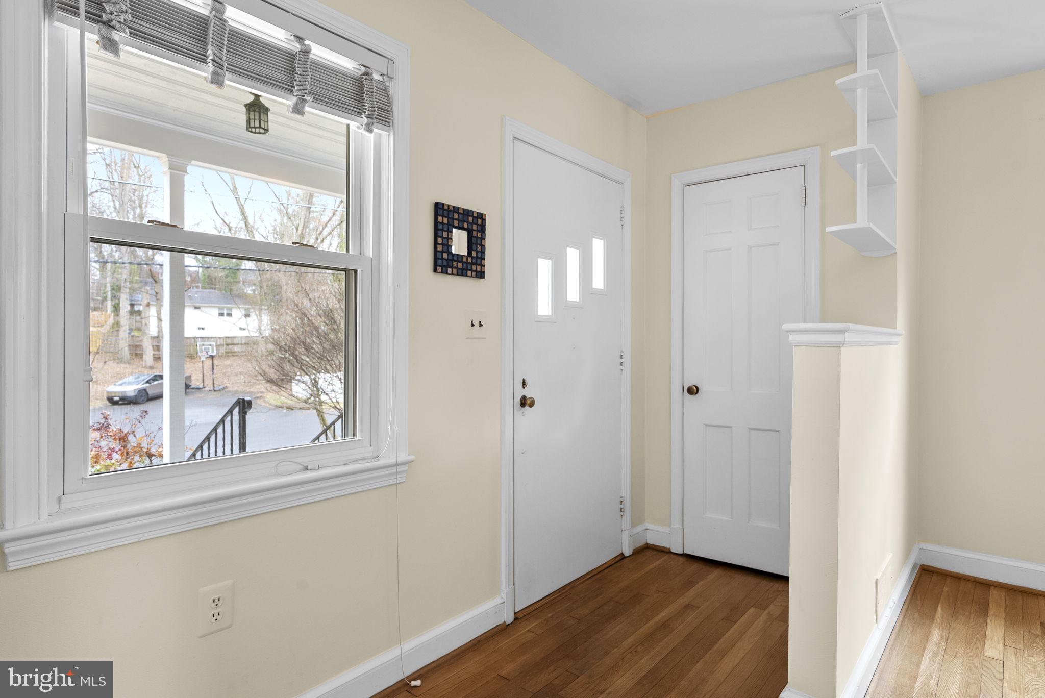 414 Hillmoor Drive Silver Spring, MD 20901 - Photo 7 of 49 a view of an empty room with wooden floor and a window