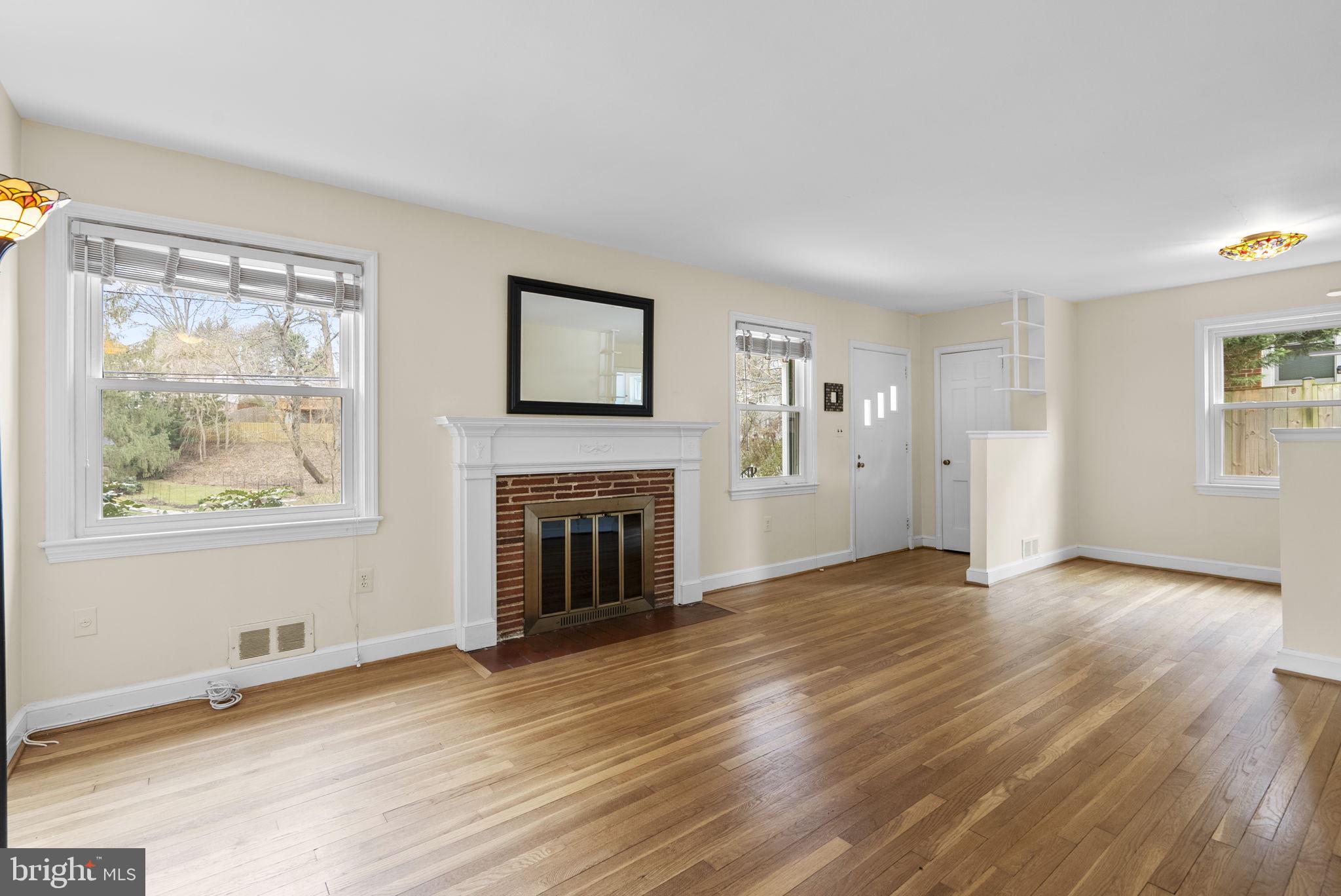 414 Hillmoor Drive Silver Spring, MD 20901 - Photo 8 of 49 a view of empty room with wooden floor and fireplace