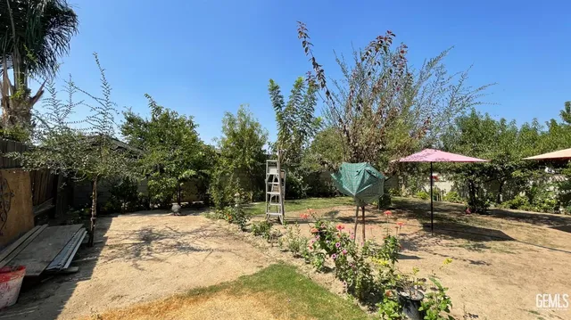 a view of a backyard with chairs