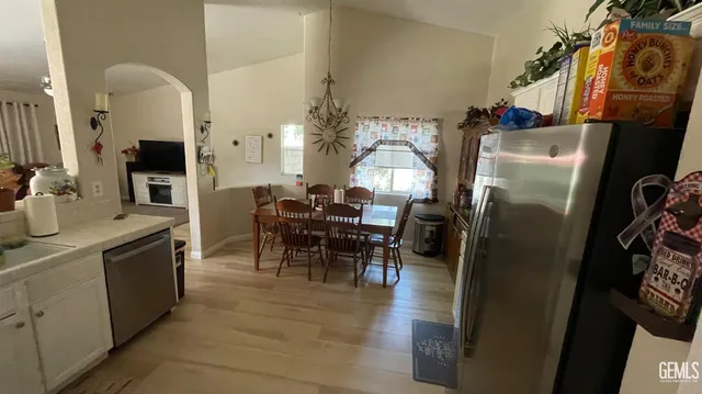 a dining room with furniture a window and kitchen view