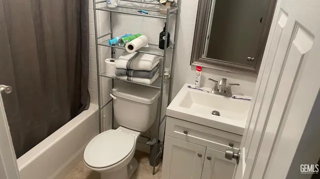 a white toilet sitting next to a bathroom sink