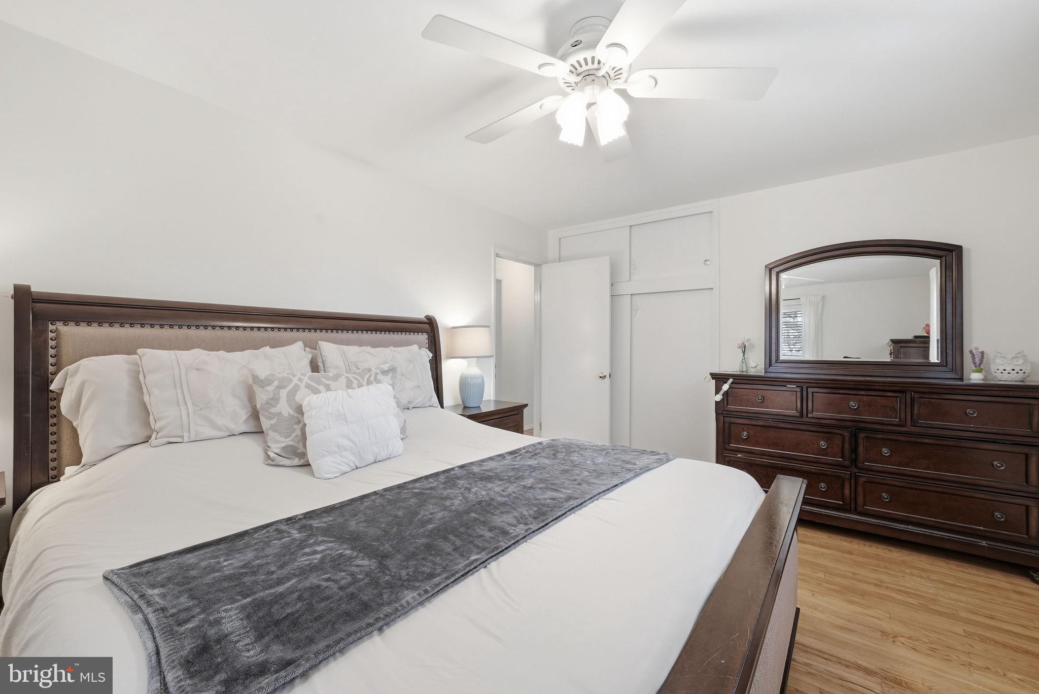 4616 Exeter Street Annandale, VA 22003 - Photo 18 of 36 a bedroom with a large bed and a chandelier