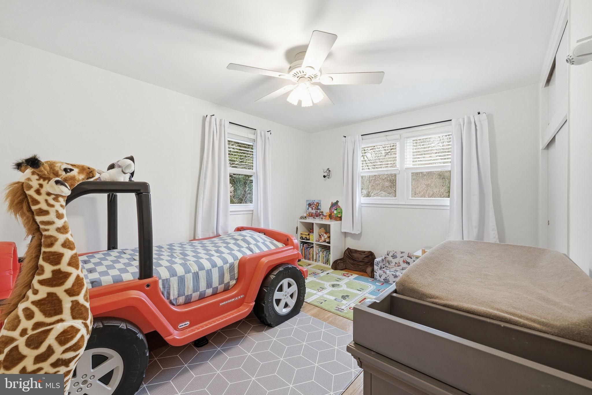 4616 Exeter Street Annandale, VA 22003 - Photo 27 of 36 a bedroom with a bed and a chandelier