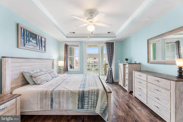 a bedroom with a large bed a chandelier and a mirror