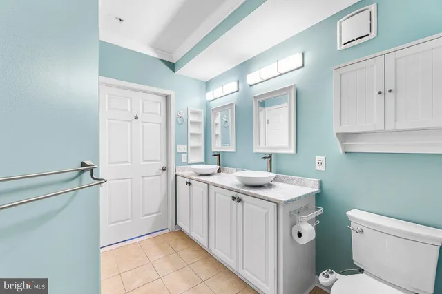 a utility room with cabinets washer and dryer