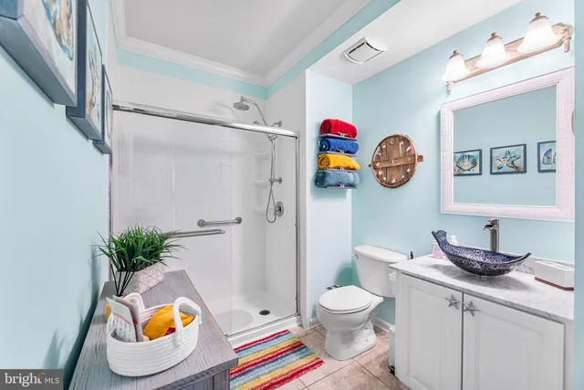 a bathroom with a sink mirror vanity and toilet
