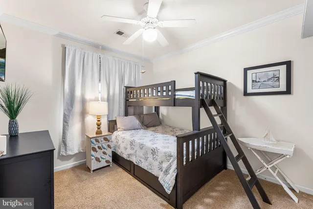 a bedroom with a bed and potted plants with the wooden floor