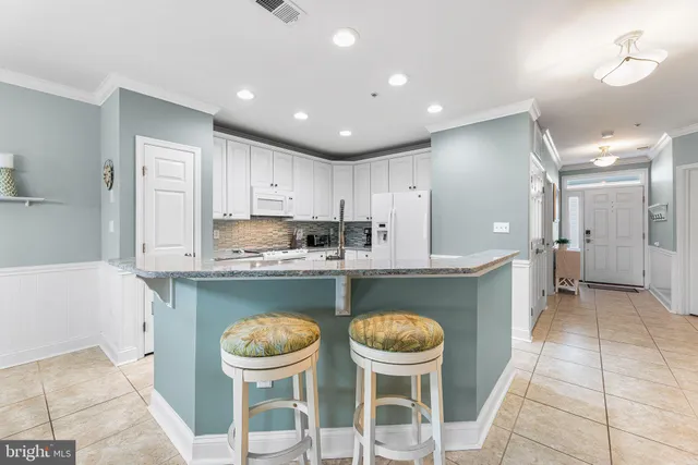 a kitchen with a stove a refrigerator and a sink