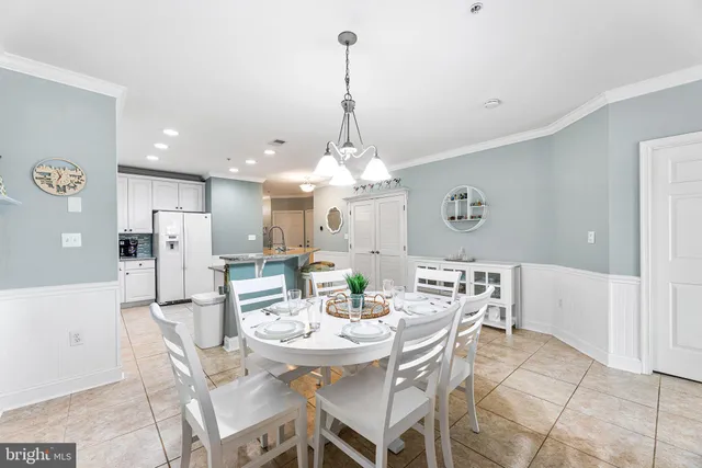 a view of a dining room with furniture and a chandelier