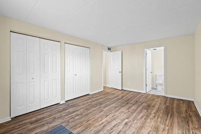 a view of a room with wooden floor and entryway