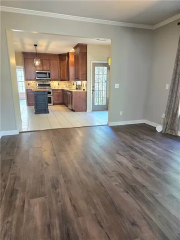 a view of a room with a ceiling fan and window