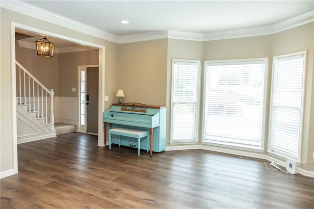 a view of a livingroom with wooden floor and chandelier
