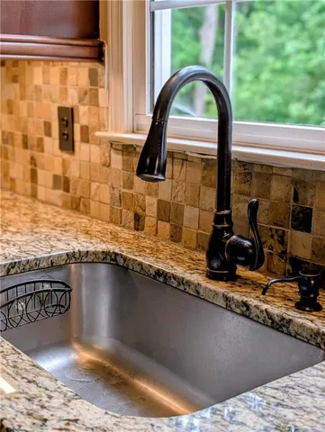 a kitchen with a stove a sink and a refrigerator