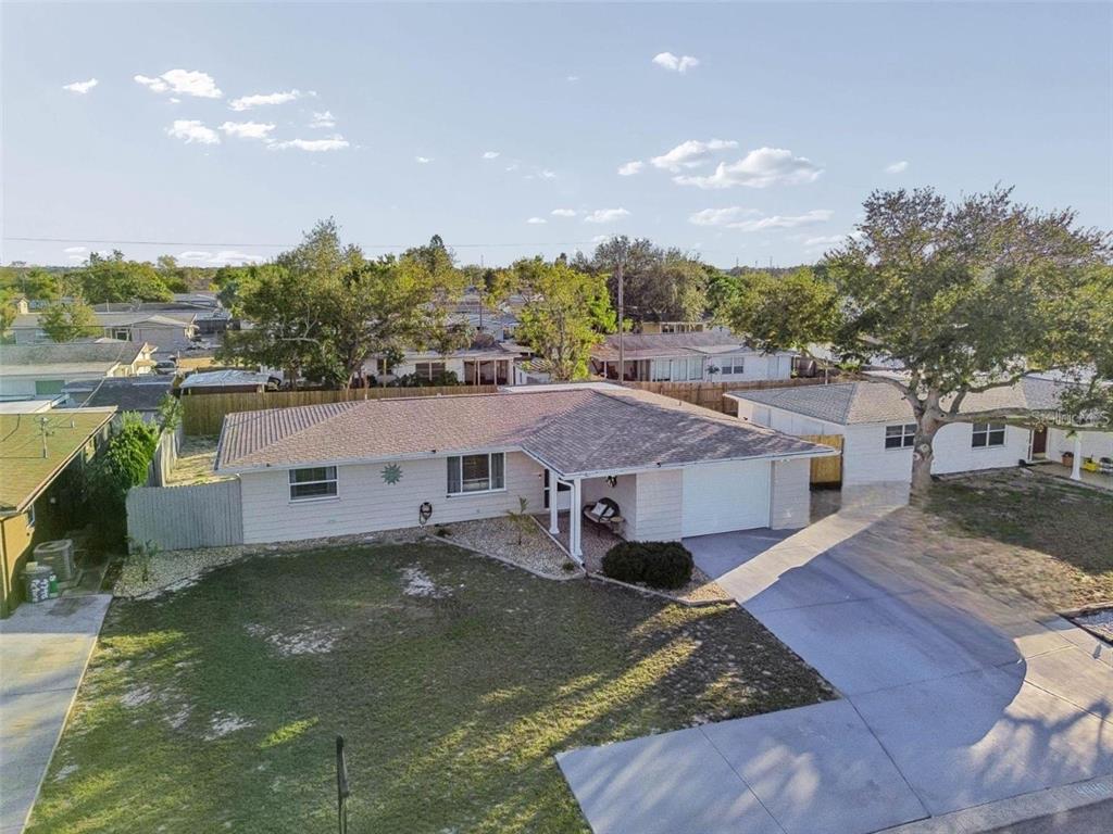 a aerial view of a house with a yard basket ball court and outdoor seating
