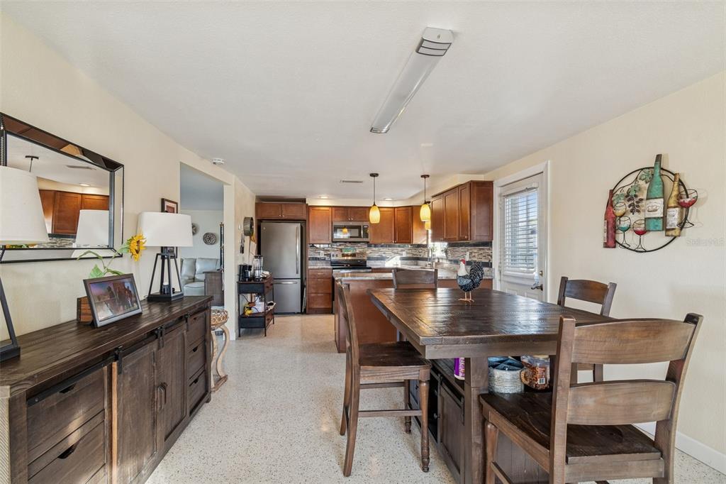 4940 Picture Avenue Holiday, FL 34690 - Photo 15 of 37 a dining room with kitchen island a table and chairs