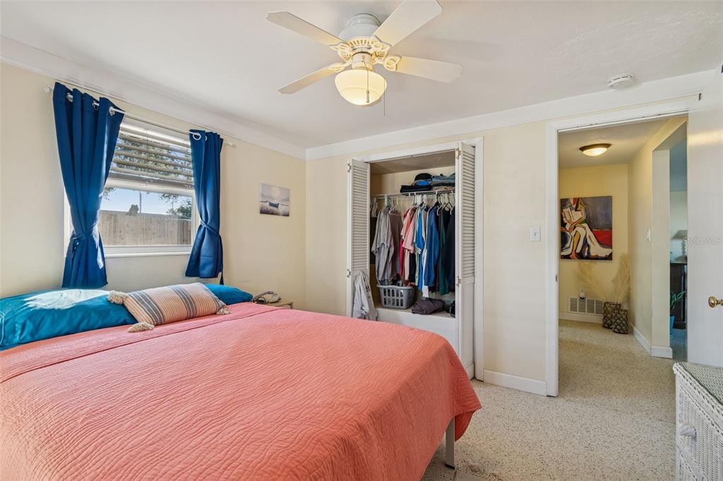 4940 Picture Avenue Holiday, FL 34690 - Photo 19 of 37 a bedroom with a large bed and a chandelier