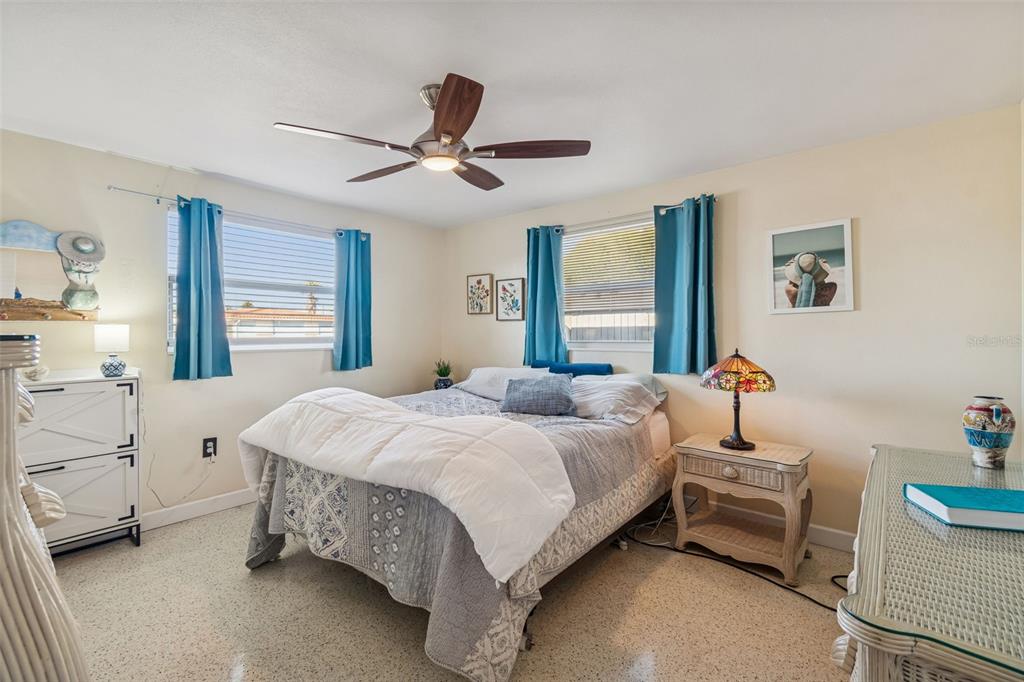 4940 Picture Avenue Holiday, FL 34690 - Photo 22 of 37 a bedroom with a bed and a chandelier