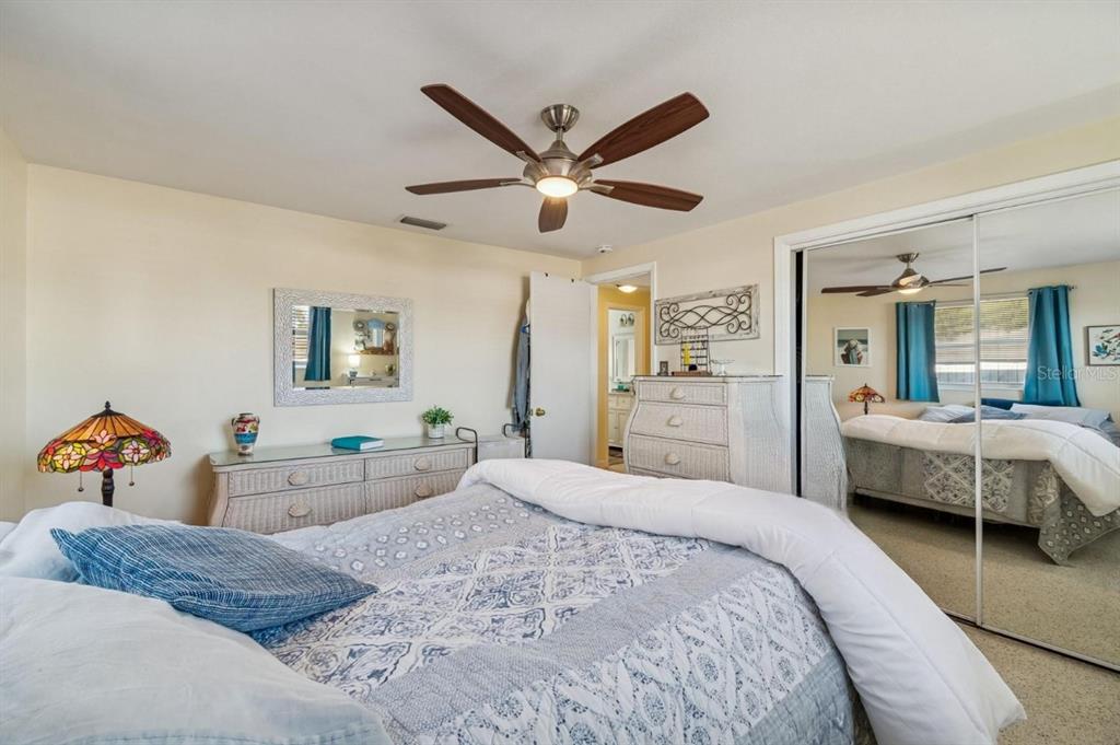 4940 Picture Avenue Holiday, FL 34690 - Photo 23 of 37 a bedroom with a bed and a large mirror