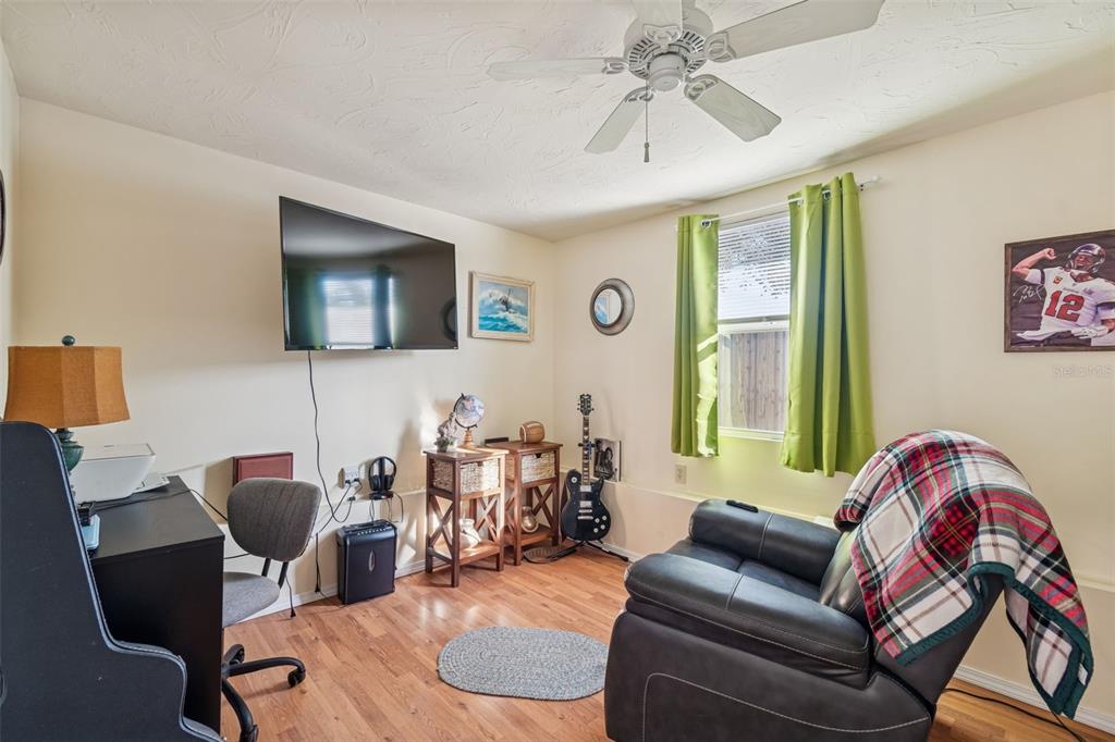 4940 Picture Avenue Holiday, FL 34690 - Photo 25 of 37 a living room with furniture and a flat screen tv