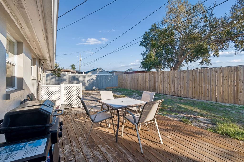 4940 Picture Avenue Holiday, FL 34690 - Photo 29 of 37 a view of a patio with table and chairs and wooden floor