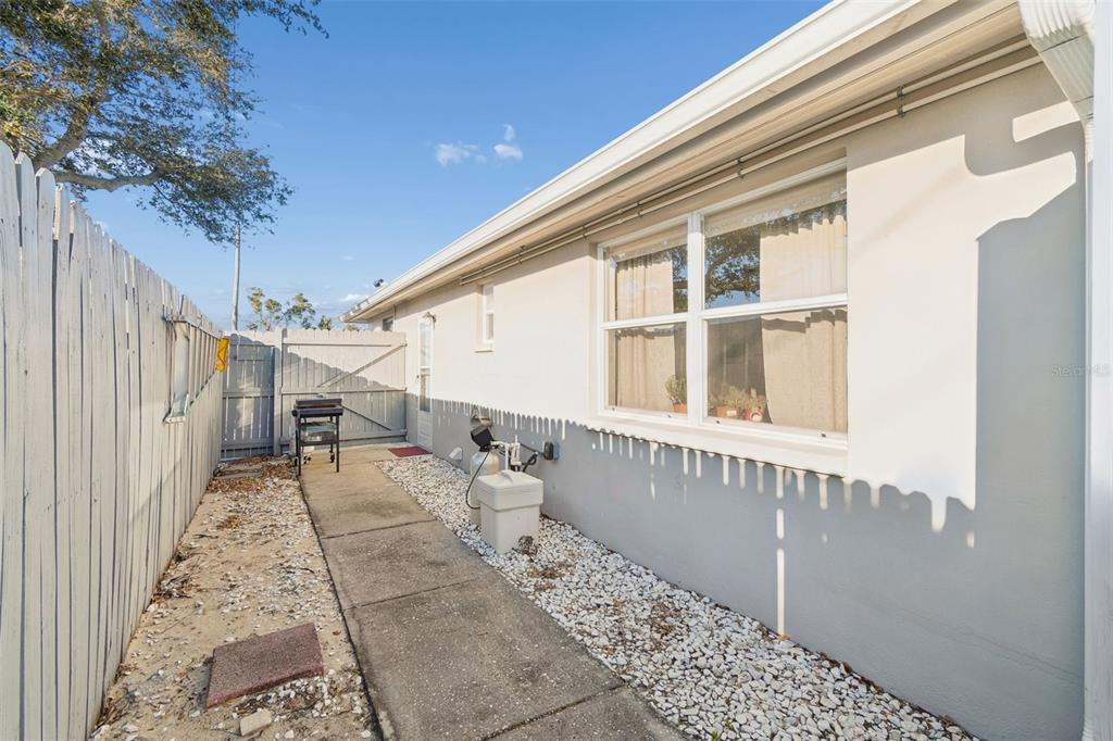 4940 Picture Avenue Holiday, FL 34690 - Photo 32 of 37 a house with a large window and wooden fence