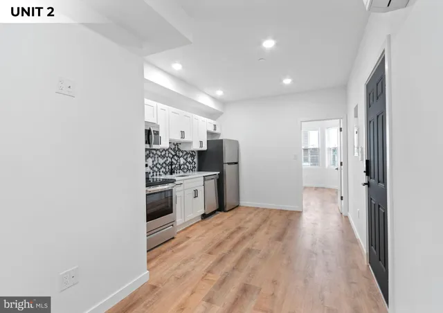 a kitchen with a refrigerator and a stove top oven